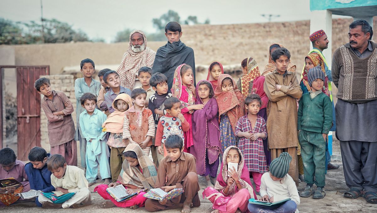 Children reading together in a rural Pakistani village